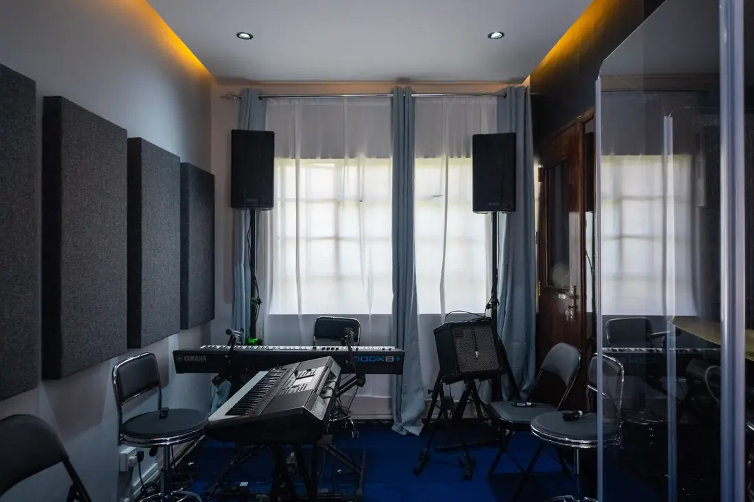 Santoori live room with keyboards, drum kit and acoustic panelling
