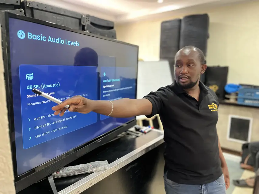 Trainer teaching audio levels to Mbaji Training Academy learners